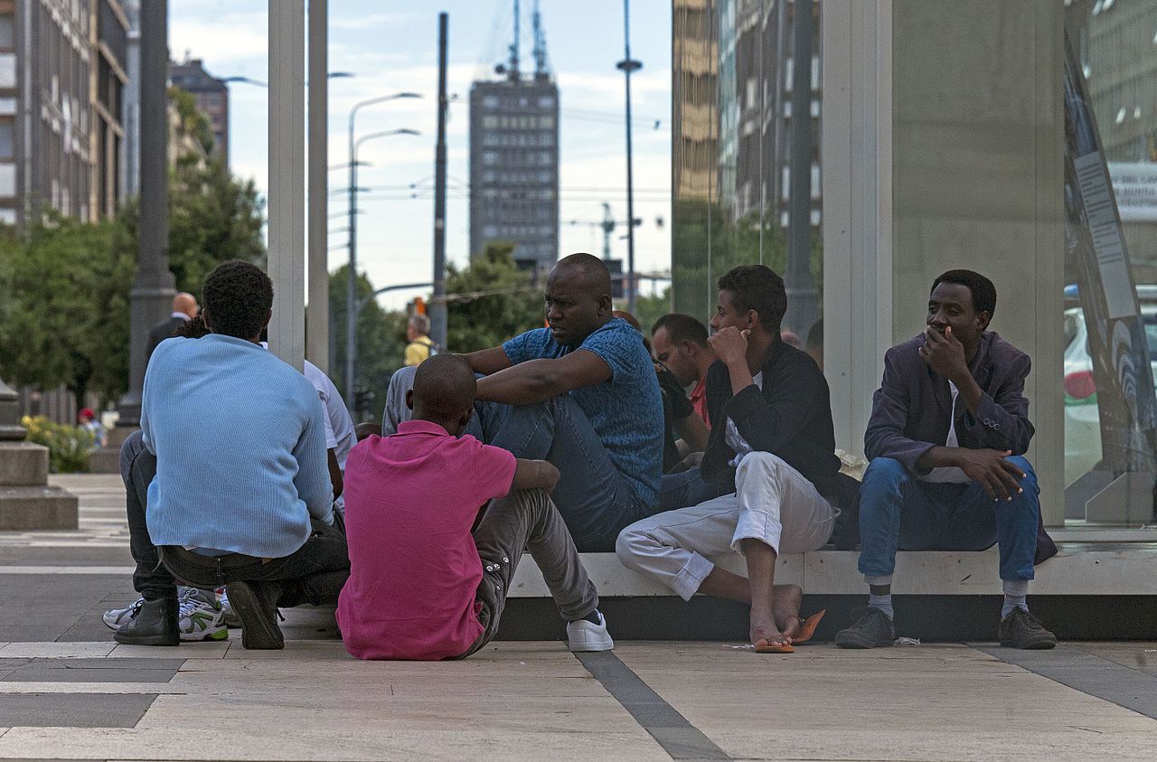 Daniel Case African men sitting on the Piazza duca dAosta Milan