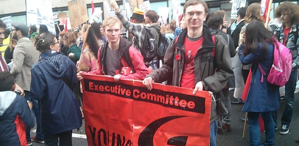 Two members of the Young Communist League holding an Executive Committee banner London by Pierre Marshall